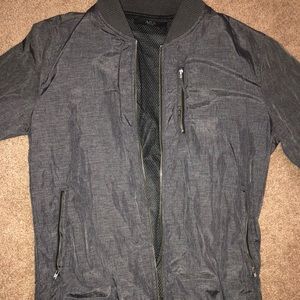 Light grey jacket with mesh on the inside.